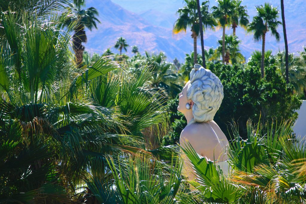 A classic sculpture nestled among lush palm trees in Palm Springs, California.