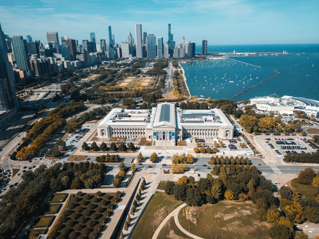 Aerial view of Chicago skyline with lakefront and museum in foreground.