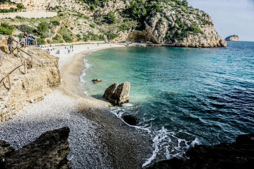 Beautiful Mediterranean beach with crystal clear waters and rocky cliffs, perfect for nature lovers.