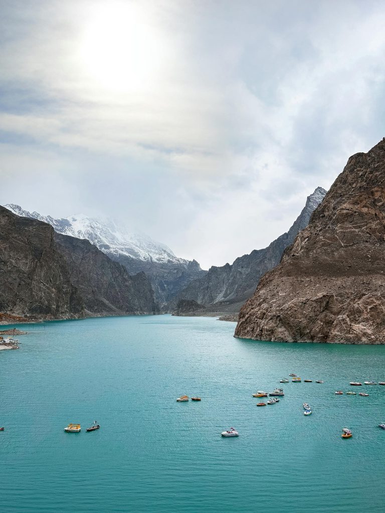 Breathtaking view of a serene turquoise lake nestled in the majestic snow-capped mountains of Garelt.