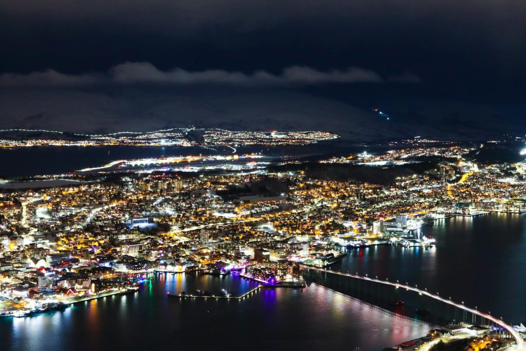 Captivating aerial photo showcasing Tromsø city lights and waterfront at night.