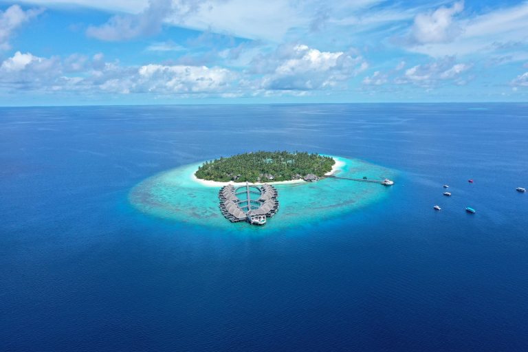 Stunning aerial view of island resort with turquoise waters, Maldives.