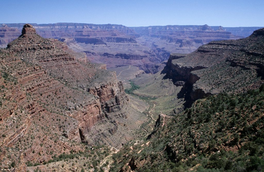 Stunning aerial view of the Grand Canyon, showcasing its rugged terrain and vibrant colors.