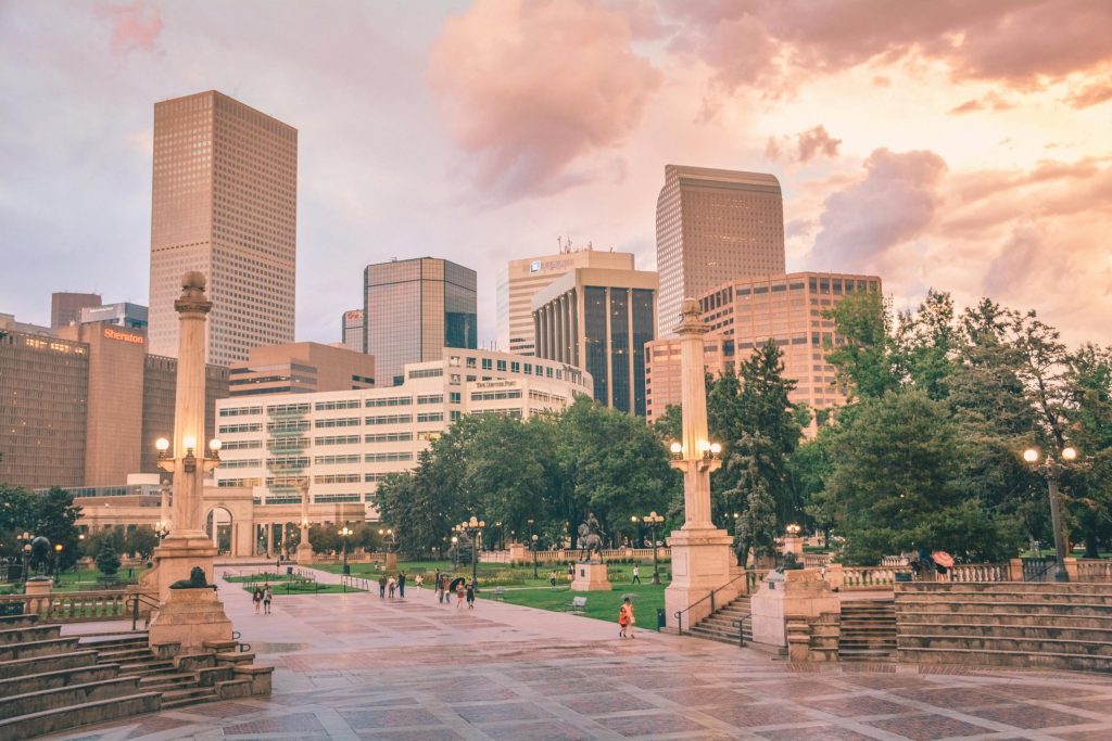 Stunning view of Denver's skyline with city park and people at sunset.