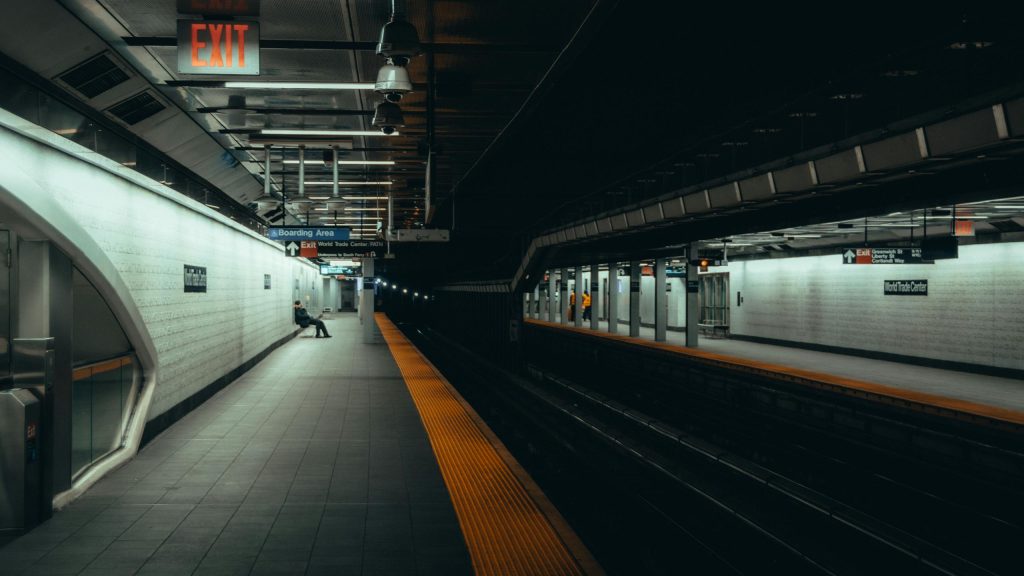 A dimly lit modern subway station at night showcasing urban architecture in New York City.