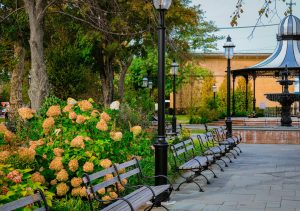 A peaceful park setting with a gazebo, flowers, and benches in Cape May, NJ.