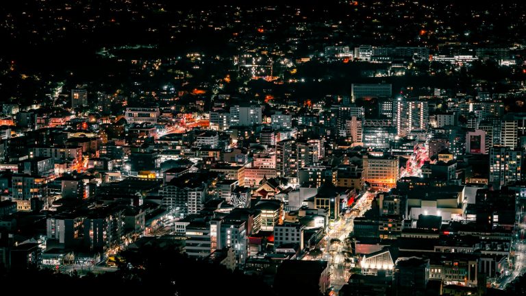 A stunning aerial view of Wellington's vibrant and illuminated cityscape during the night.