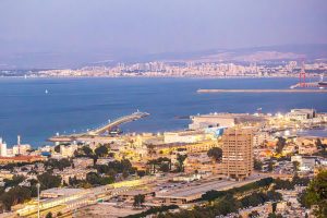 A stunning view of Haifa's harbor and cityscape in the evening light.