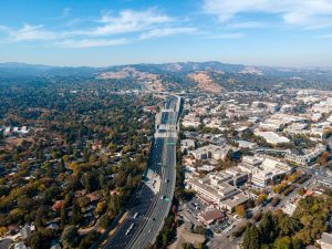 Aerial view capturing the sprawling suburbs and highway of Walnut Creek, California