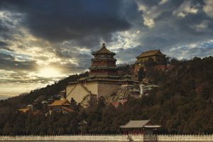 Breathtaking sunset over the historic Summer Palace, showcasing its stunning architecture and serene landscape.