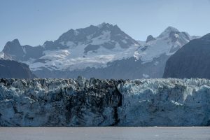 Breathtaking view of Glacier Bay with rugged ice formations and snow-capped mountains in Alaska.