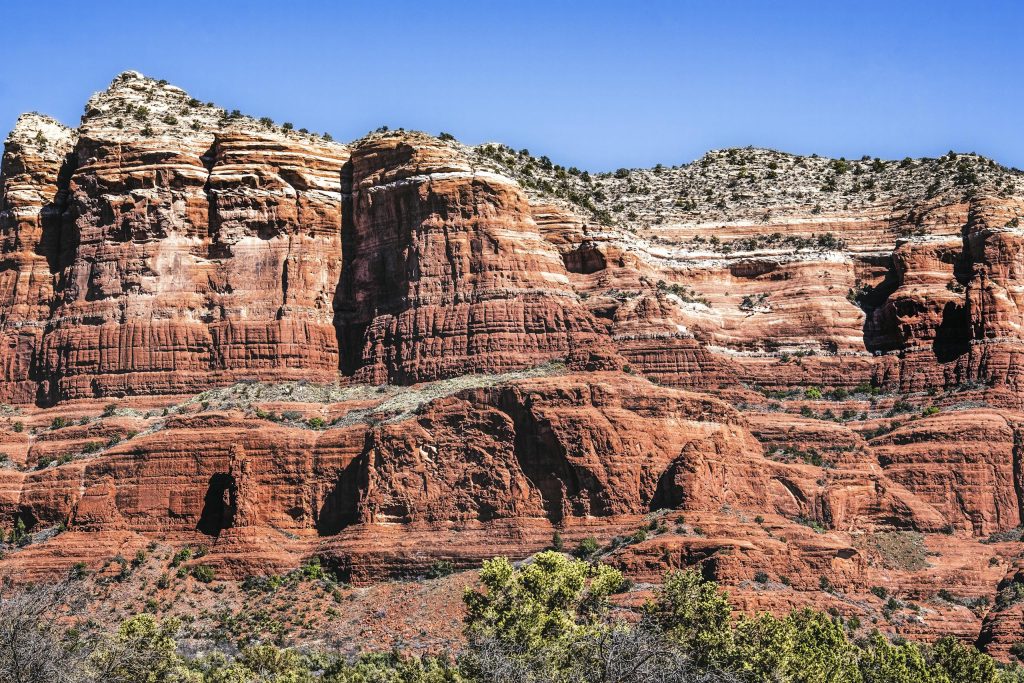 Breathtaking view of Sedona's iconic red rock formations against a clear blue sky.