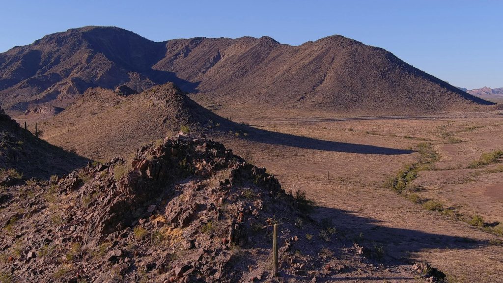 Breathtaking view of Tonopah's desert hills and mountains under a clear blue sky.
