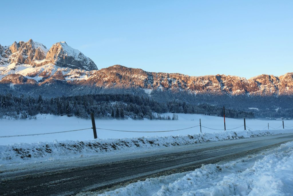 Breathtaking winter scene of snowy mountains in Sankt Johann in Tirol, Austria at sunrise.