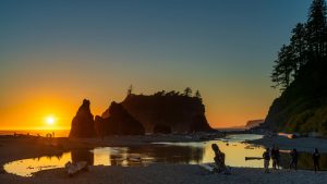 Capture of Ruby Beach at sunset with silhouettes and reflections, showcasing the iconic sea stacks.