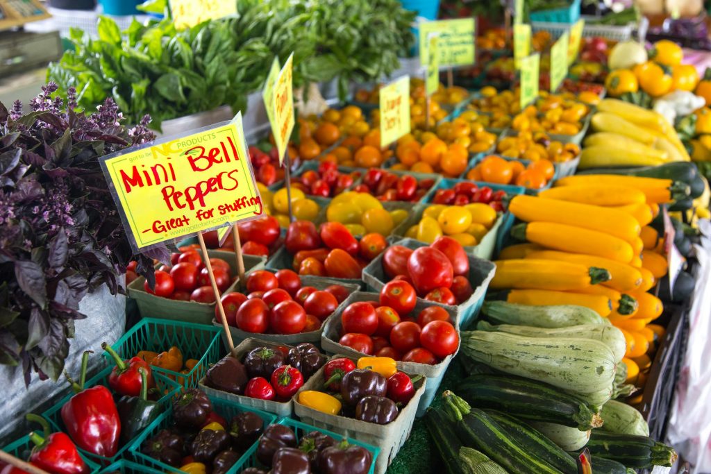 Colorful assortment of fresh vegetables at an outdoor farmers market in North Carolina.
