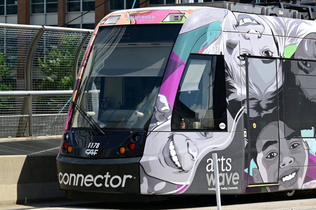 Colorful streetcar with artistic design in Cincinnati city center.