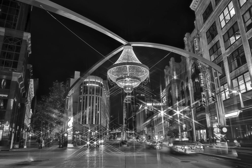 Dramatic black and white photograph of Playhouse Square in Cleveland, Ohio, featuring the iconic chandelier at night.