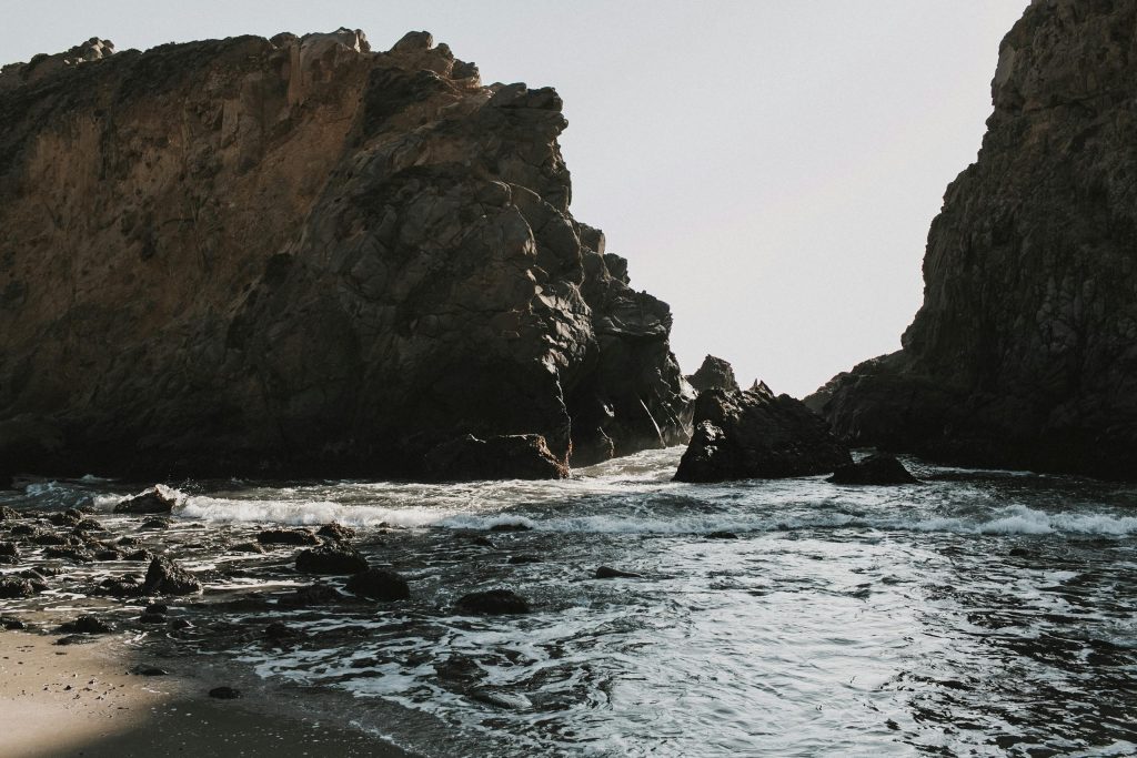 Dramatic rock formations along the Big Sur coast, California, capturing the meeting of sea and shore.
