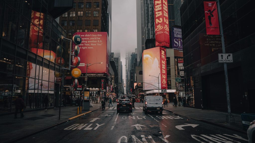 Dynamic city life at Times Square with illuminated signs and bustling streets in New York City.