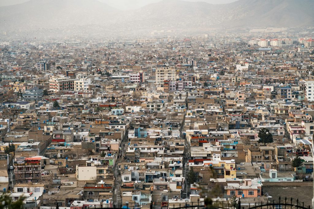 Expansive aerial view of Kabul city, showcasing urban density and surrounding mountains in Afghanistan.