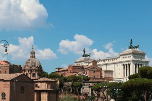 Experience the classic beauty of Rome's iconic buildings against a clear blue sky.