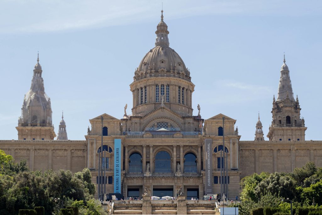 Front view of the National Art Museum of Catalonia showcasing its grand architecture under a clear sky.