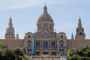Front view of the National Art Museum of Catalonia showcasing its grand architecture under a clear sky.
