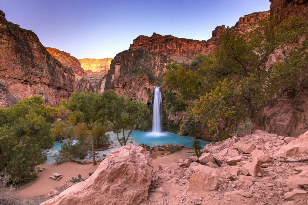 Havasu Falls cascades into a turquoise pool in Arizona's Grand Canyon.