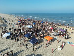 Lively beach party scene on South Padre Island with crowds enjoying summer festivities.