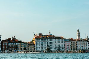Picturesque waterfront view of historic Venetian architecture along Venice's Grand Canal.