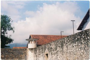 Scenic view of a historic stone wall and watchtower under a blue sky in Ba Ria - Vung Tau, Vietnam.
