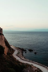 Serene view of the Aegean Sea and coastal path in Koroni, Greece.