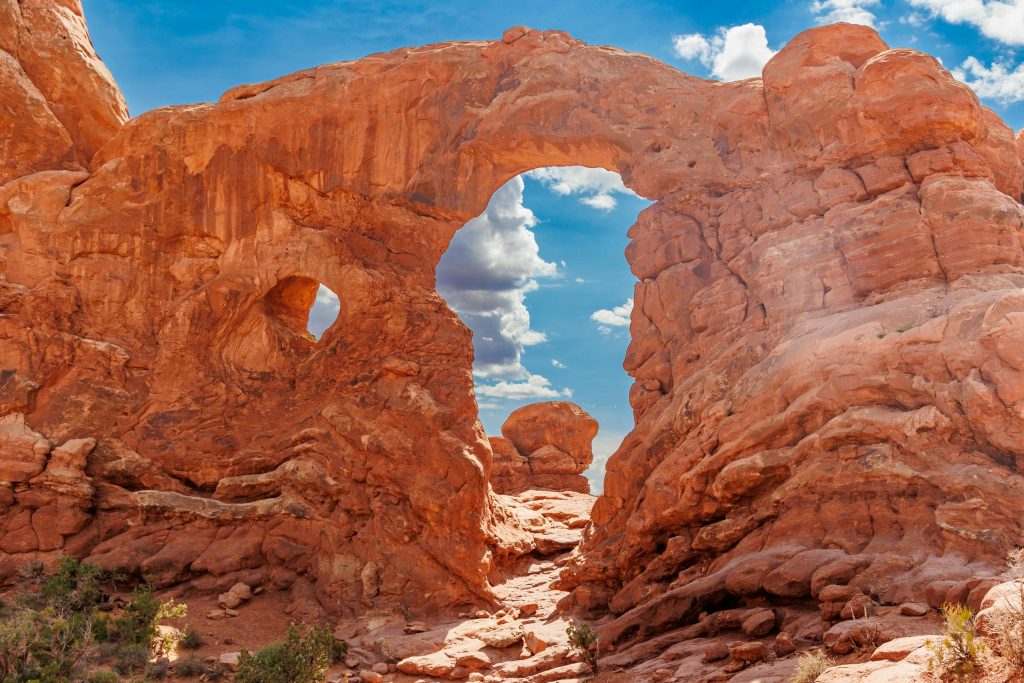 Stunning red rock arch in Kanab, Utah under a bright blue sky.
