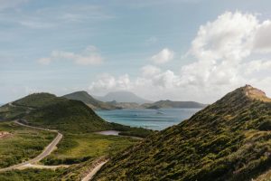 Stunning view from Timothy Hill Overlook capturing the lush landscape, winding road, and ocean in the distance.
