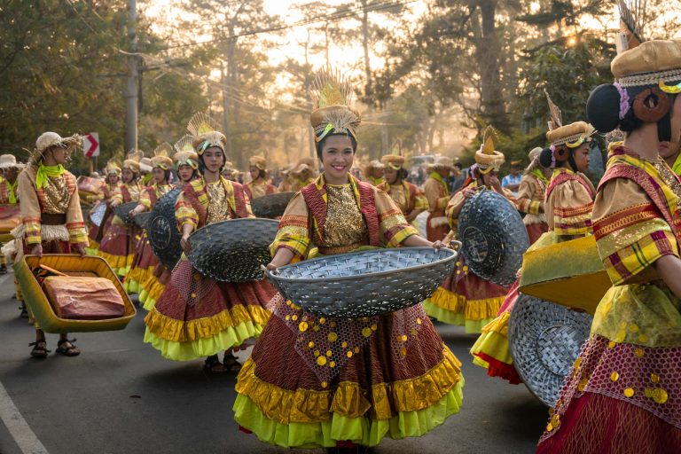 Vibrant traditional festival parade in Baguio City, showcasing colorful costumes and cultural heritage.
