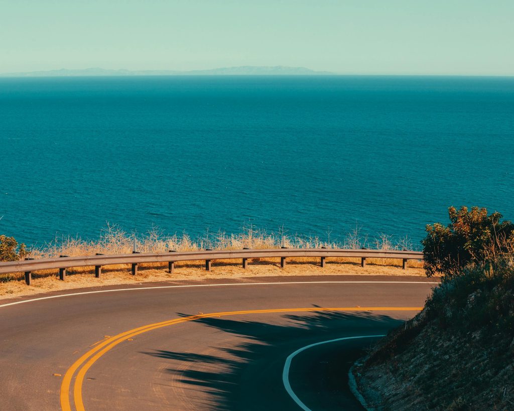 Winding road along the Pacific Ocean in Malibu, California. Perfect for road trips.