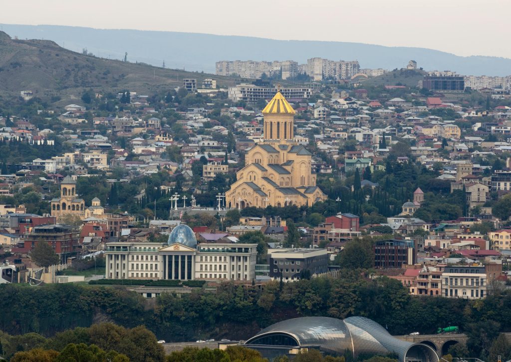 Aerial view of Tbilisi showcasing the Holy Trinity Cathedral and cityscape.