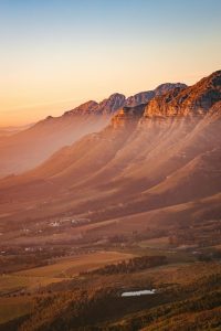 Breathtaking view of Stellenbosch mountains and valleys at sunrise, capturing nature's beauty.