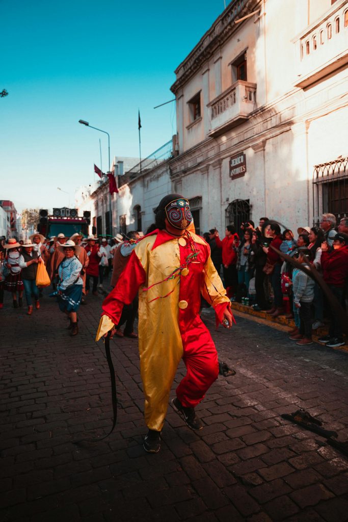Colorful performer in a costume parades through the vibrant streets of Arequipa, Peru.