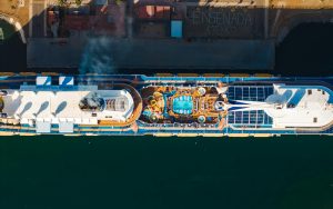 Stunning aerial shot of a cruise ship docked at Ensenada, Mexico, showcasing its pool deck.